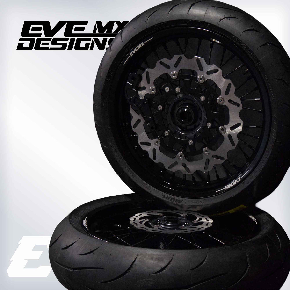 Motorcycle wheel with disc brake and tire on a white background, featuring Eve MX Designs branding.
