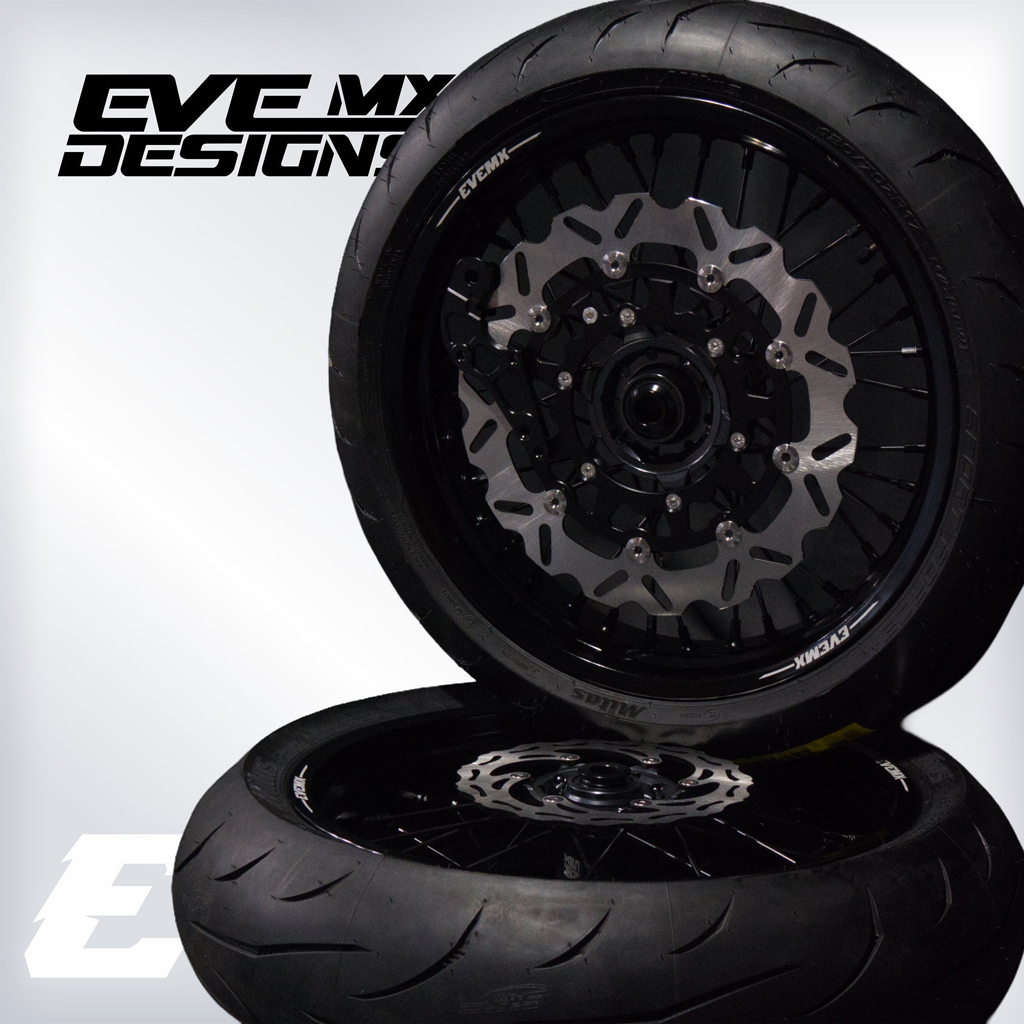 Motorcycle wheel with disc brake and tire on a white background, featuring Eve MX Designs branding.